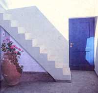 Blue door, staircase and shadow photograph
